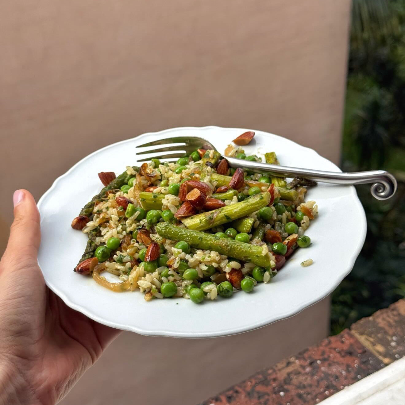 Stainless steel spiral cutlery with salad on white plate outside