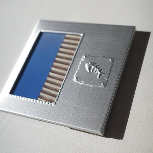 smal square metal picture frame with an embossed fish