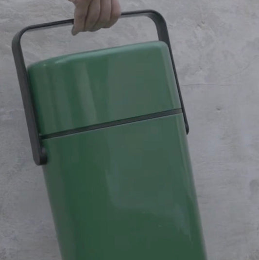 Person holding a green retro wine cooler case