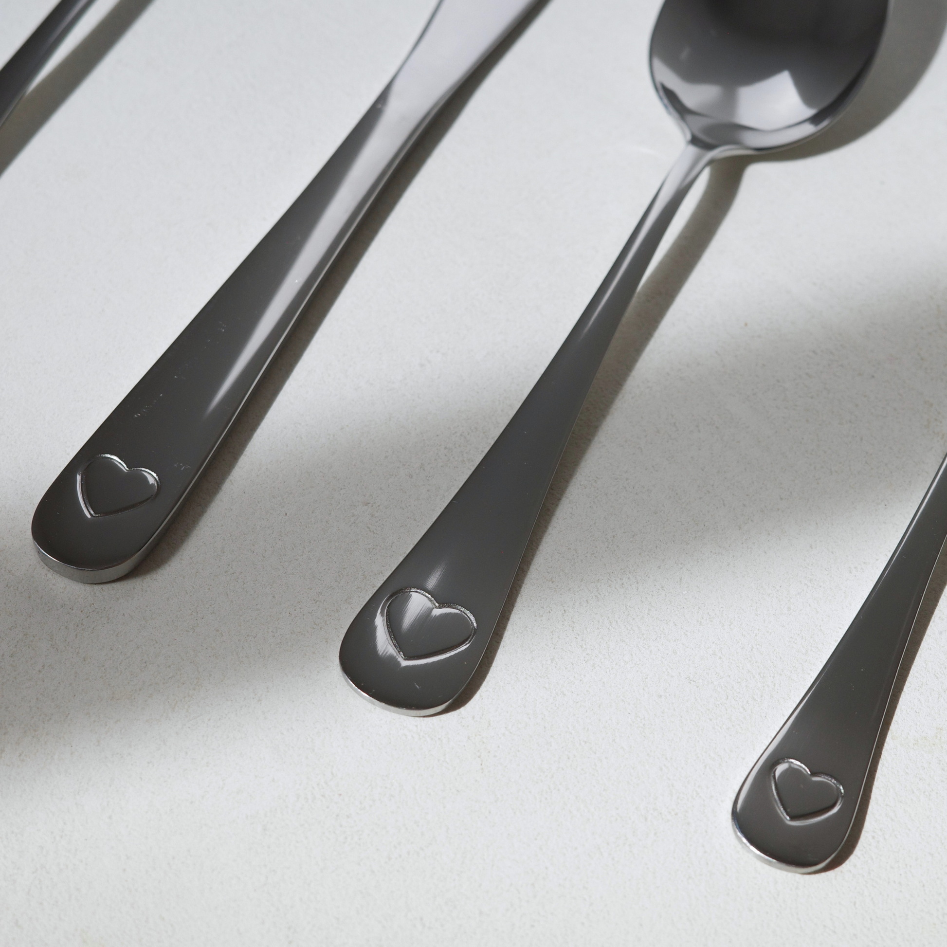 Close up of engraved heart on stainless steel cutlery 