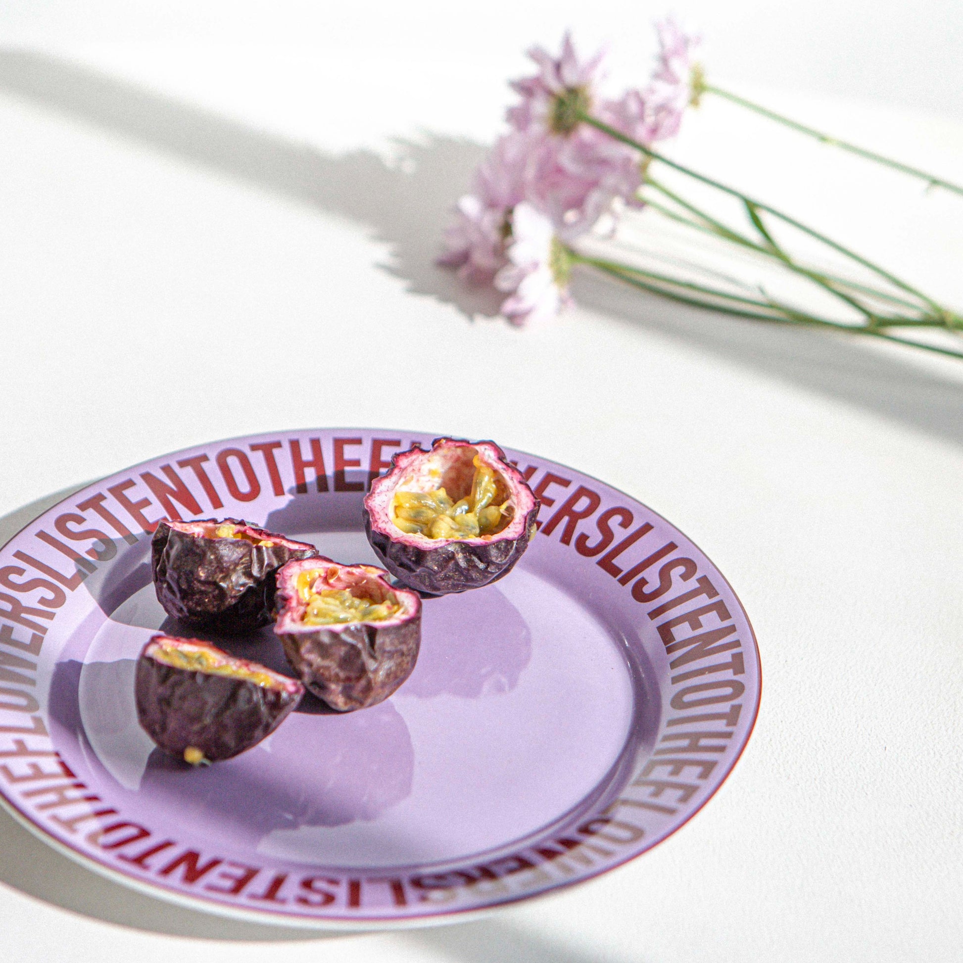 purple ceramic plate with passionfruit